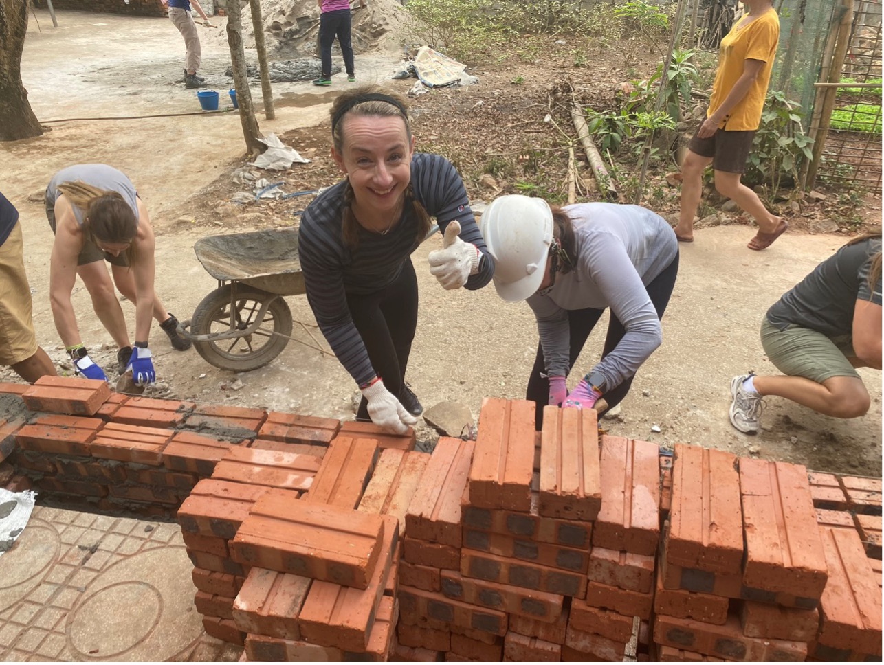 Hospice trekkers building a brick wall in Vietnam whilst on trek