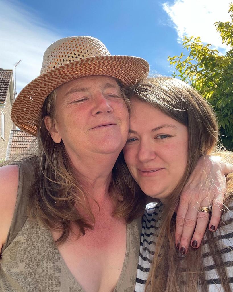 Debbie and her daughter smiling together in the garden