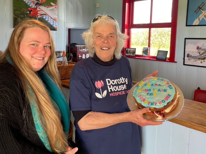 Dorothy House supporter holding a cake stood next to her niece 