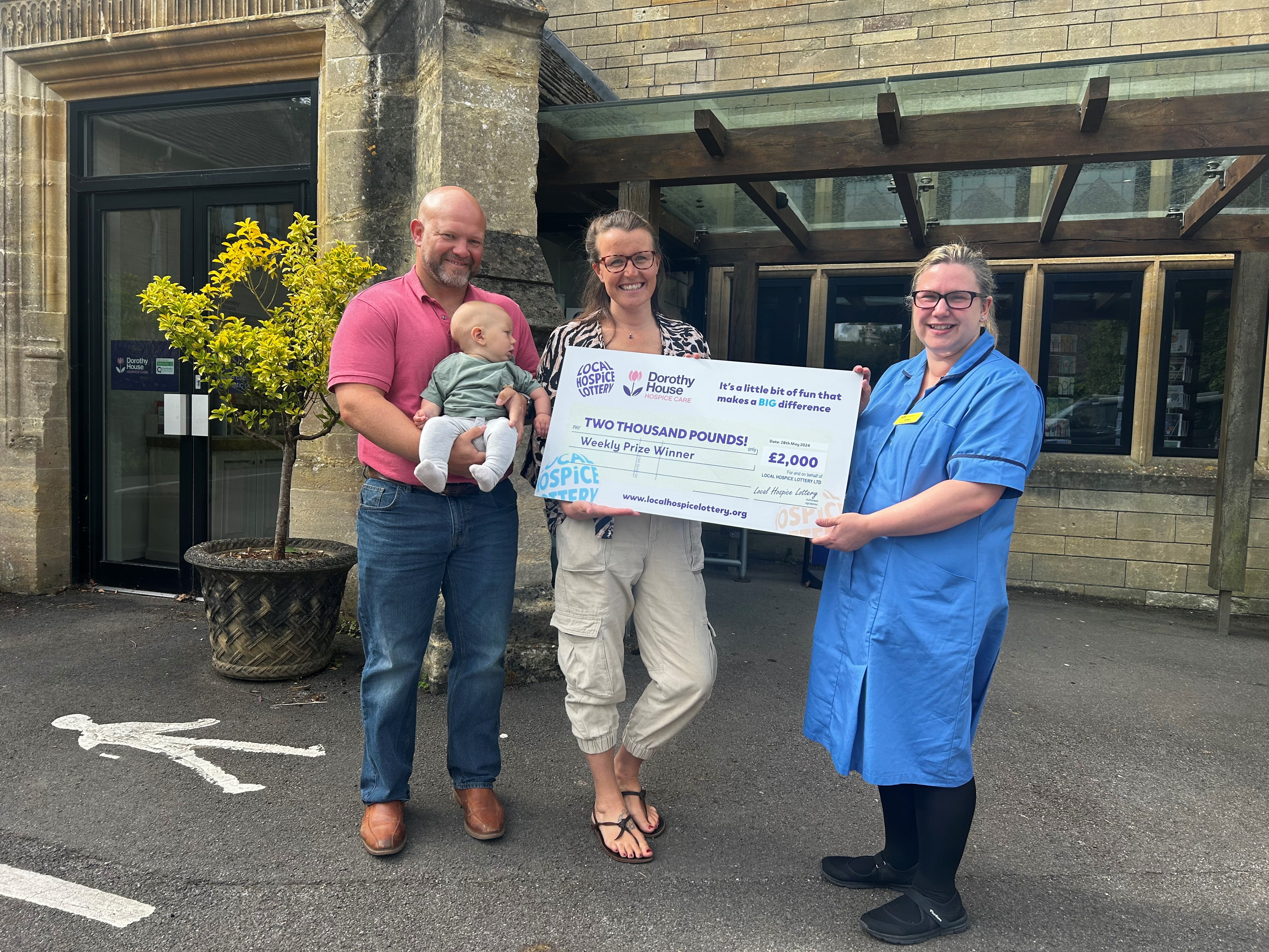 Matt, Cooper, and Amy being presented with the winners cheque by a nurse